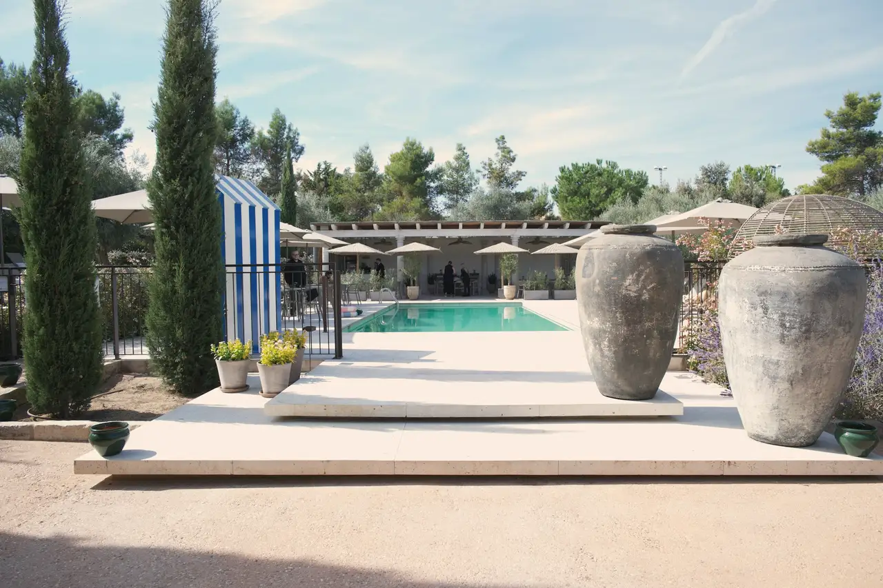 The pool, two tall jars, the cypresses